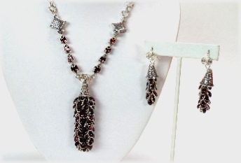 Faceted and Cabochon Garnets framed in sterling silver, designed as a Talus Necklace.